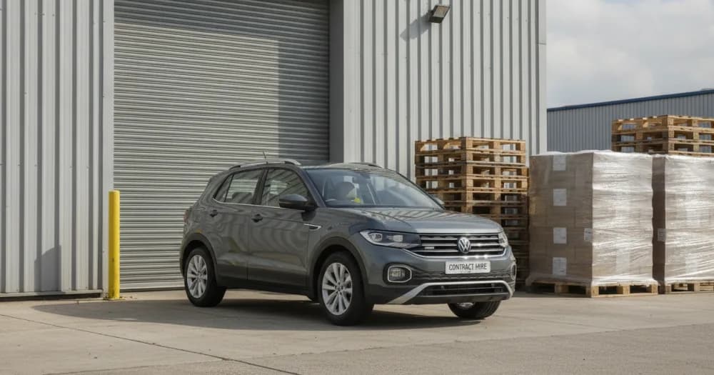 Small SUV at a warehouse loading bay, illustrating what a volkswagen t-cross lease costs and includes. Small SUV at a warehouse loading bay, illustrating what a volkswagen t-cross lease costs and includes.